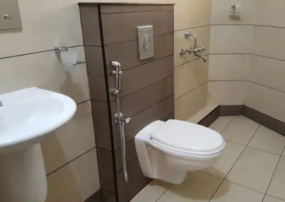 a bathroom with a toilet and a sink at The Rubis in Kottakkal