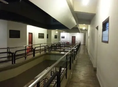 a hospital hallway with a row of tables and benches at The Rubis in Kottakkal