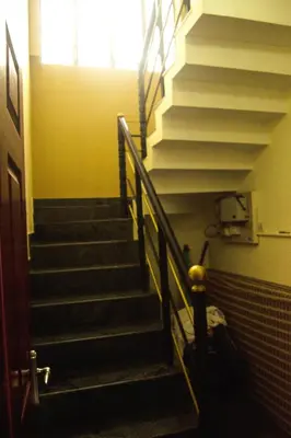 a set of stairs in a building with a window at Skylarc Inn in Ooty