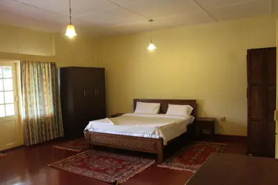 a bedroom with a bed in a room at Sirukundra Garden Bungalow in Vālpārai