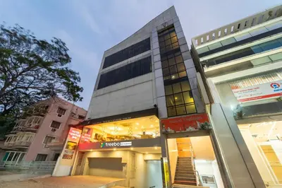 a tall building with a store in front of it at Treebo Venition Inn in Coimbatore