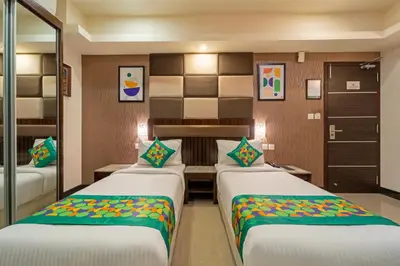 a room with two beds in a room at Treebo Venition Inn in Coimbatore