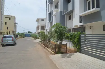 a car parked on a street next to a building at Blackroots Serviced Apartments in Coimbatore