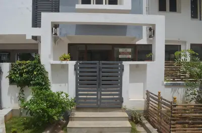 a house with a gate in front of it at Blackroots Serviced Apartments in Coimbatore