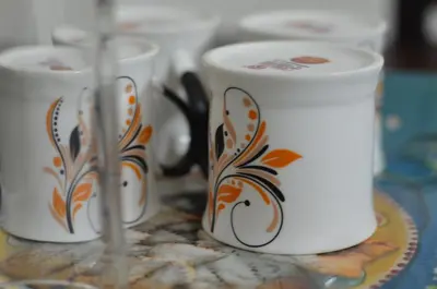 three coffee mugs sitting on a table at Blackroots Serviced Apartments in Coimbatore
