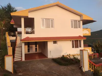 a house with a view of the front of it at Mist Resorts Ooty in Ooty