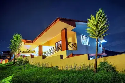 a house with a palm tree in front of it at Mist Resorts Ooty in Ooty