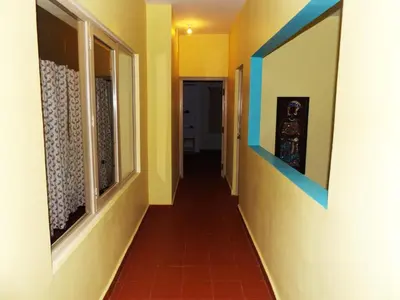 a hallway of a house with yellow and blue walls at Silent Wild in Masinagudi