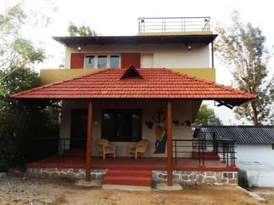 a small house with a red roof at Silent Wild in Masinagudi