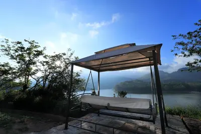 a bath tub sitting next to a body of water at Ottway Hills Mattupetty Dam in Munnar