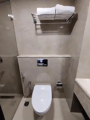 a bathroom with a white toilet and a sink at Issacs Residency in Munnar