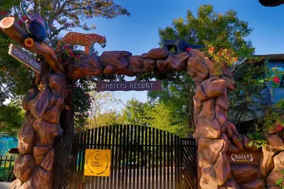an entrance to a childrens resort with a wooden arch at Chalets Resort Masinagudi in Ooty