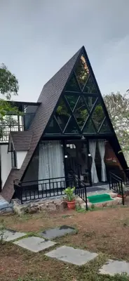 a house with a gambrel roof with a pool at Chalets Resort Masinagudi in Ooty
