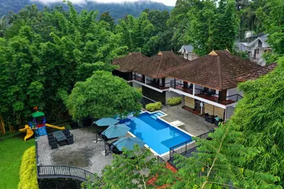 an aerial view of a house with a swimming pool at Athirapally Green Trees in Athirappilly