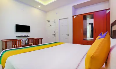 a bedroom with a bed and a television in it at Itsy Hotels Kottaram Residency, 10 Mins To Botanical Garden in Ooty