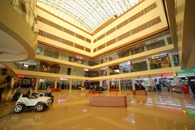 a shopping mall with a car parked in the middle at Vavas Inn & Suites in Perintalmanna