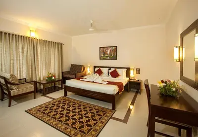 a hotel room with a bed and a desk at Le Coffee Resort in Sultan Bathery