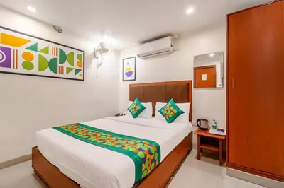 a bedroom with a large white bed in a room at Treebo Sam Residency in Coimbatore