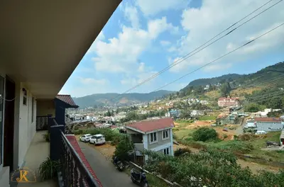 a view of a city from a balcony at Royal Serene Villas in Ooty