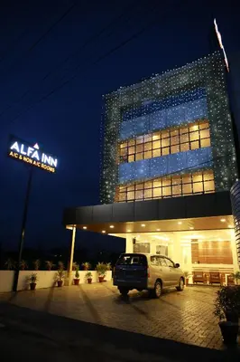a car parked in front of a building at night at Alfa Inn in Nedumbassery