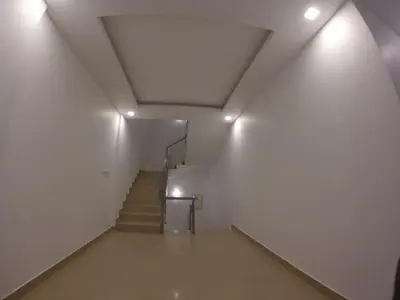 a staircase in an empty building with lights at Alfa Inn in Nedumbassery