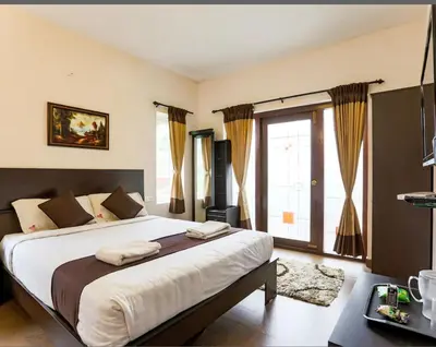 a bedroom with a large bed and a large window at Paradise Perfect - Nonsmoking Non alcoholic No unmarried couples in Ooty