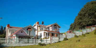 a house on the side of a hill at Pine View Stay Ooty in Ooty
