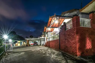 a night view of a building with a street at Via St Clouds - Nr Government Botanical Garden in Ooty