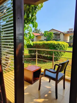 a balcony with a chair and a table and a view at Bandipur Wildlife Resort & Spa, Bandipur in Bandipūr