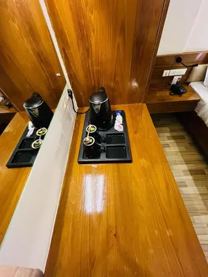 a wooden table with two burners on top of it at Queens Tourist Home in Badagara