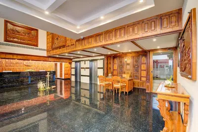 a dining room with a table and chairs at Sterling Guruvayur in Guruvāyūr