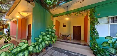 a house with green and colorful walls and plants at Wayanad Royal Stream in Kalpetta