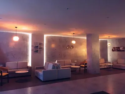 a living room with couches and tables and lights at Alhind Calicut Tower in Kozhikode