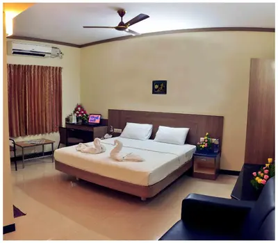 a bedroom with a bed with two swans on it at SK Residency in Coimbatore