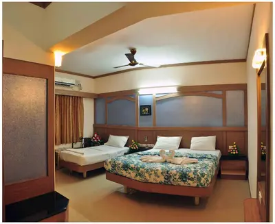 a hotel room with two beds at SK Residency in Coimbatore