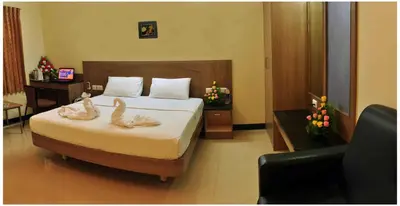 a bedroom with a bed with two swans on it at SK Residency in Coimbatore