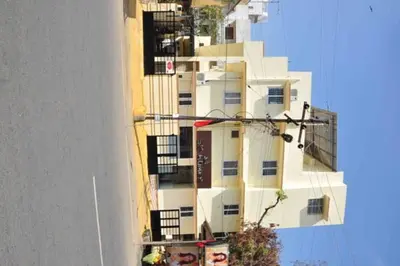 a tall white building with balconies on the side of it at SK Residency Unit 2 in Coimbatore