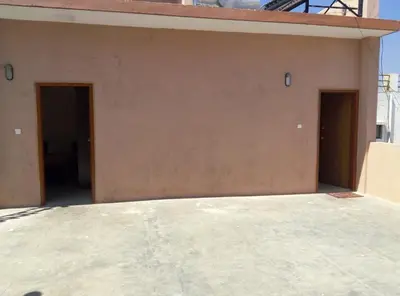 a building with two doors on the side of it at Suvarna Compact in Mysore