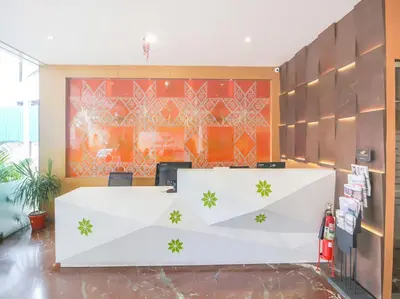 an office with a white reception desk in a room at Samudra Mysore in Mysore