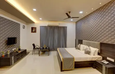 a hotel room with a bed and a television at Nadhiyoram River Retreat in Cochin