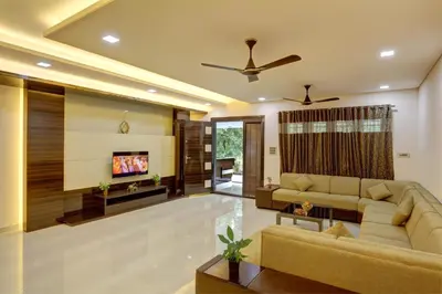a living room with a couch and a tv at Nadhiyoram River Retreat in Cochin