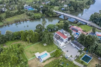 an aerial view of a house next to a river at Nadhiyoram River Retreat in Cochin