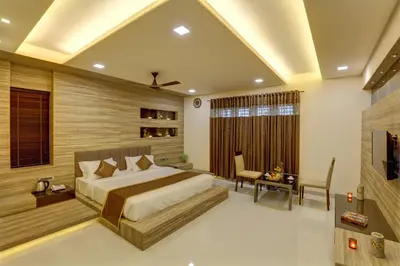 a bedroom with a bed and a desk and a chair at Nadhiyoram River Retreat in Cochin