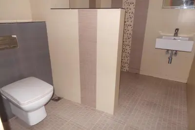 a bathroom with a toilet and a sink at Hotel Span in Kozhikode