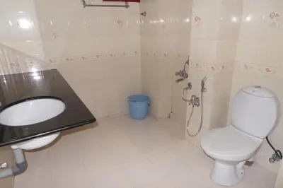 a bathroom with a toilet and a sink at Hotel Span in Kozhikode