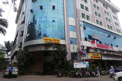 a tall building with motorcycles parked in front of it at Hotel Span in Kozhikode