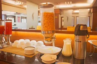 a kitchen counter with a blender and some dishes at President Hotel in Mysore