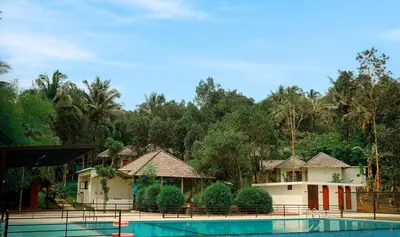 a view of a resort with a swimming pool at Century Village Resort in Mananthavady