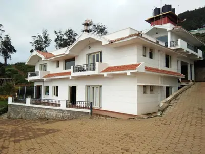 a house on a brick road at Berry Hills Resort in Ooty
