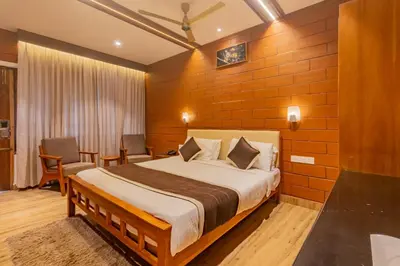a hotel room with a bed and a table and chairs at The Nest Inn Resort in Masinagudi
